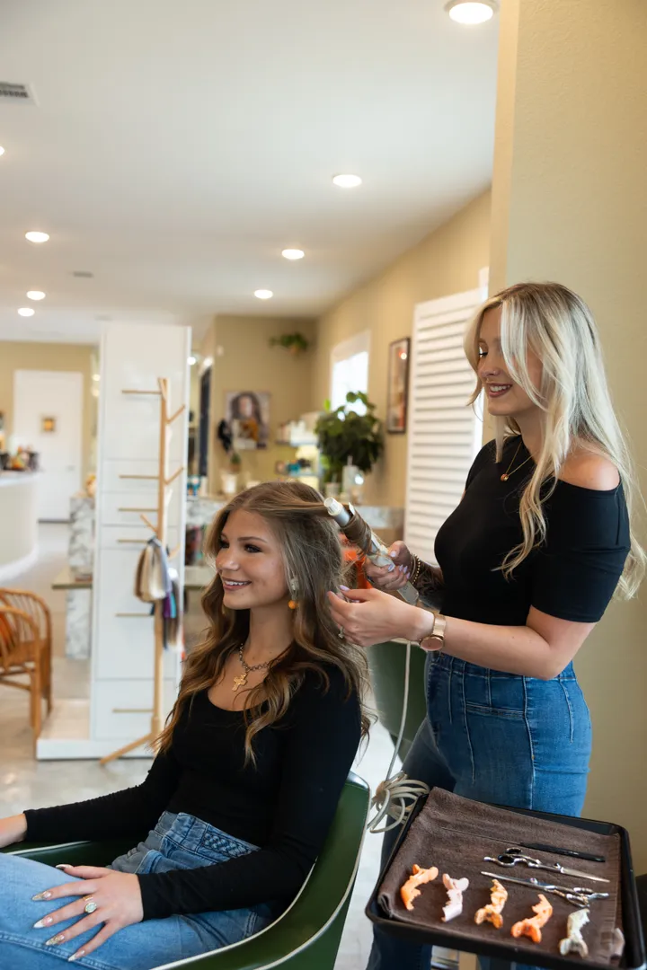 A stylist consulting with a guest before styling