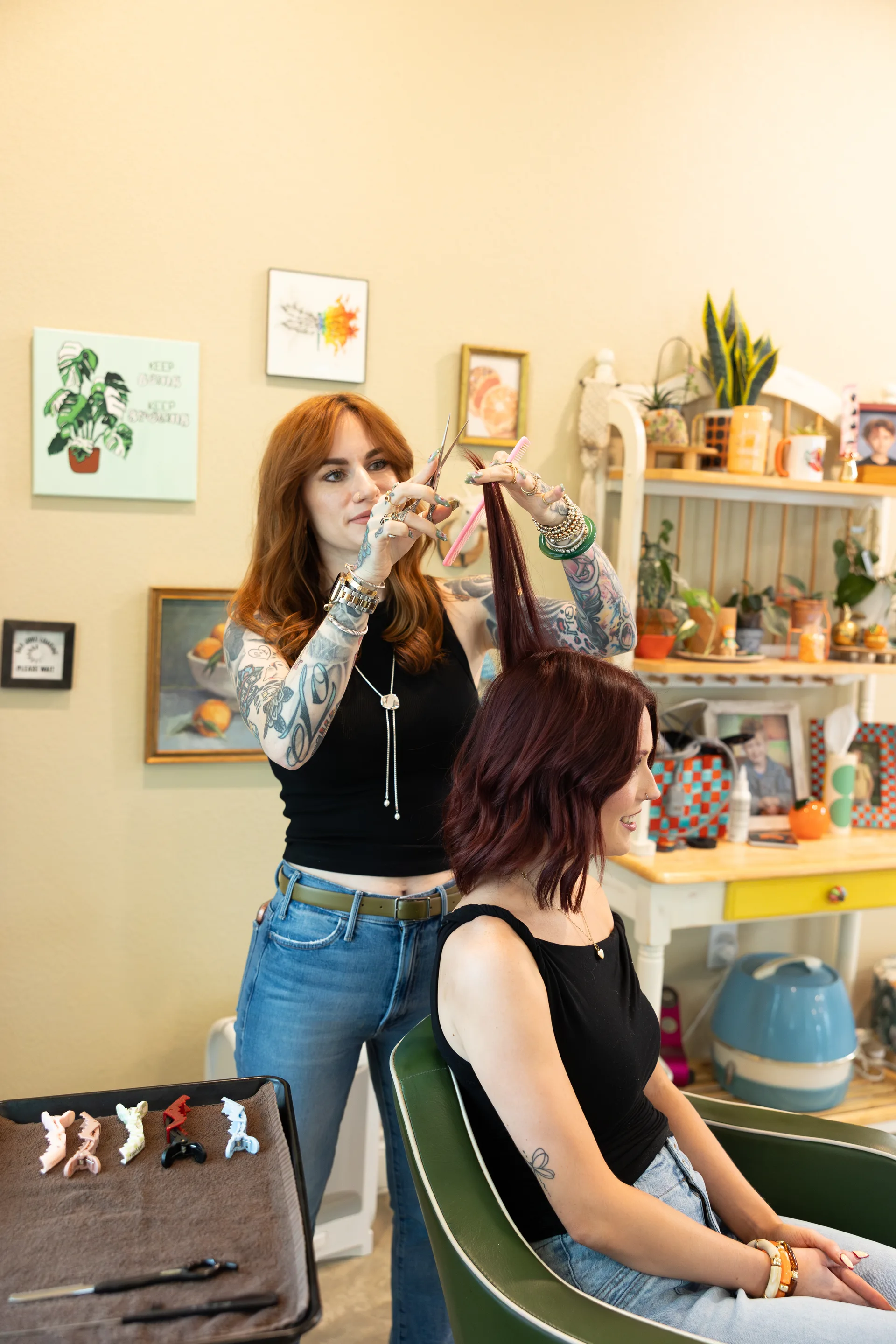 Brittni cutting a guest’s hair at Hart Studios