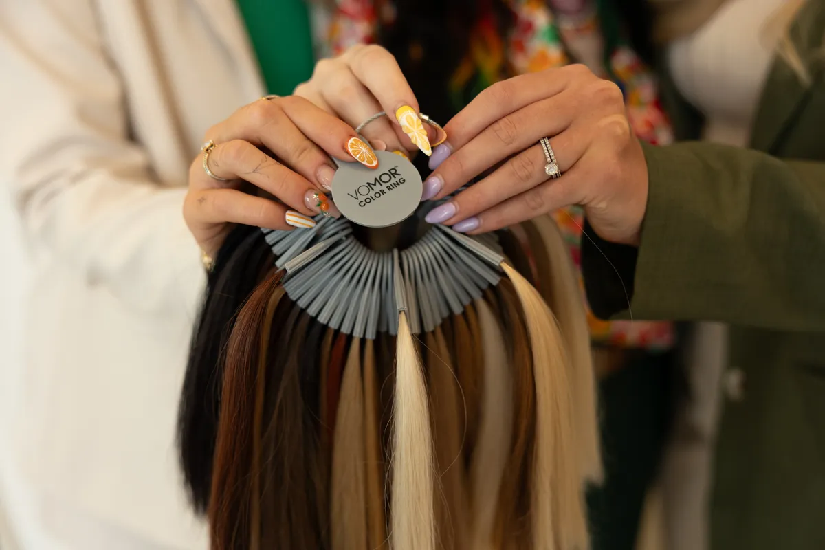 A Hart team member holding extension color samples