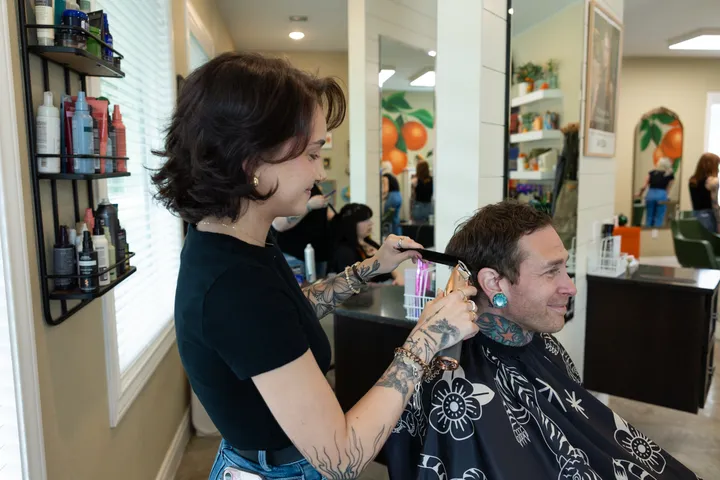 A men’s haircut in progress at Hart Studios