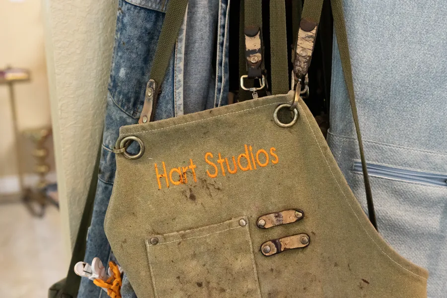 A Hart Studios stylist’s embroidered apron and haircutting tools
