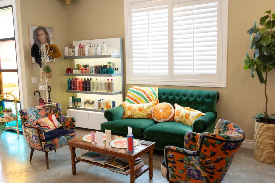Green velvet seating and citrus details in Hart’s colorful lounge