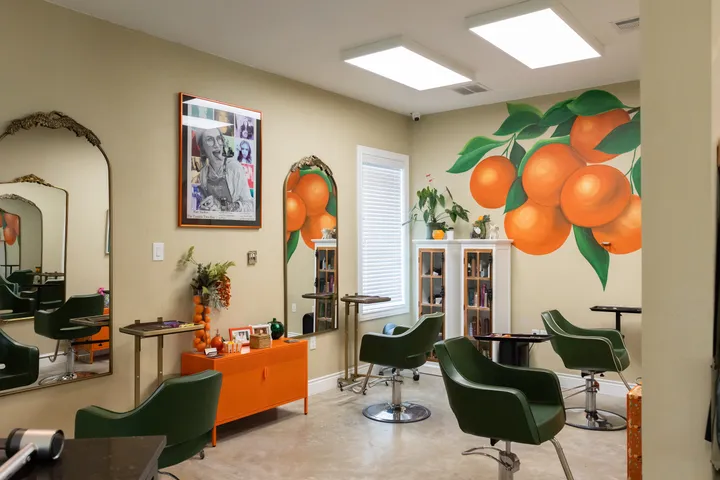 The orange mural and styling stations at Hart Studios